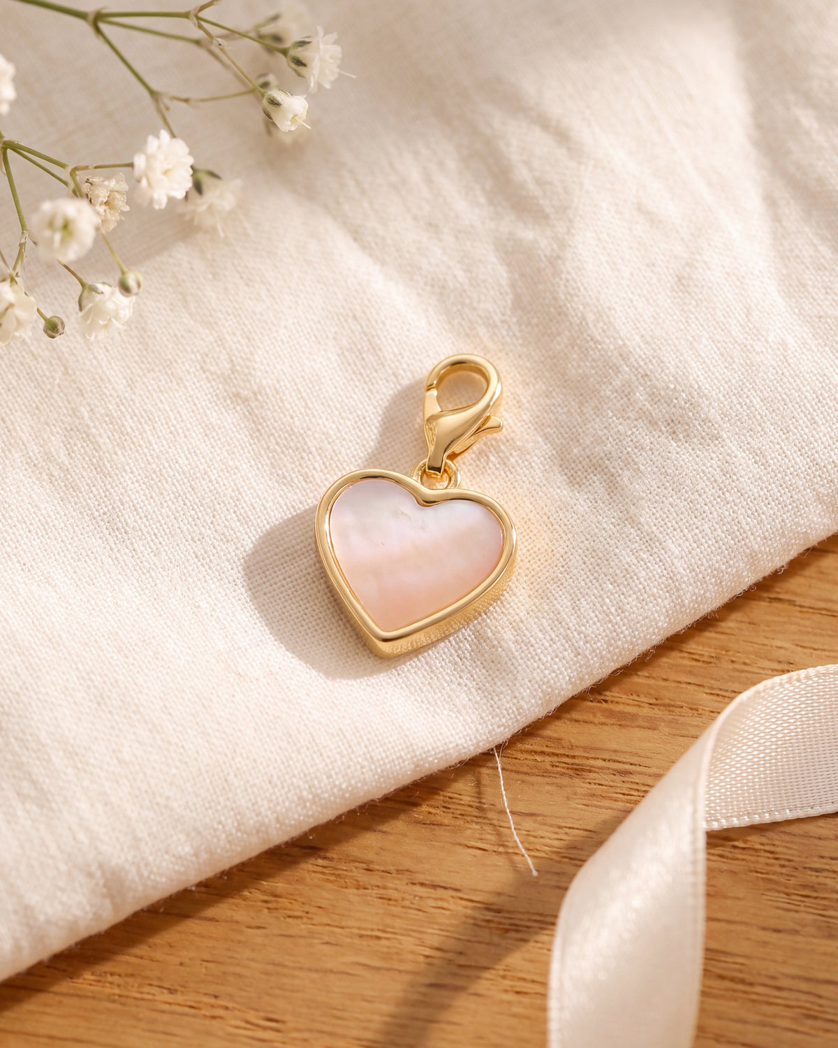 The pearl heart charm on its own