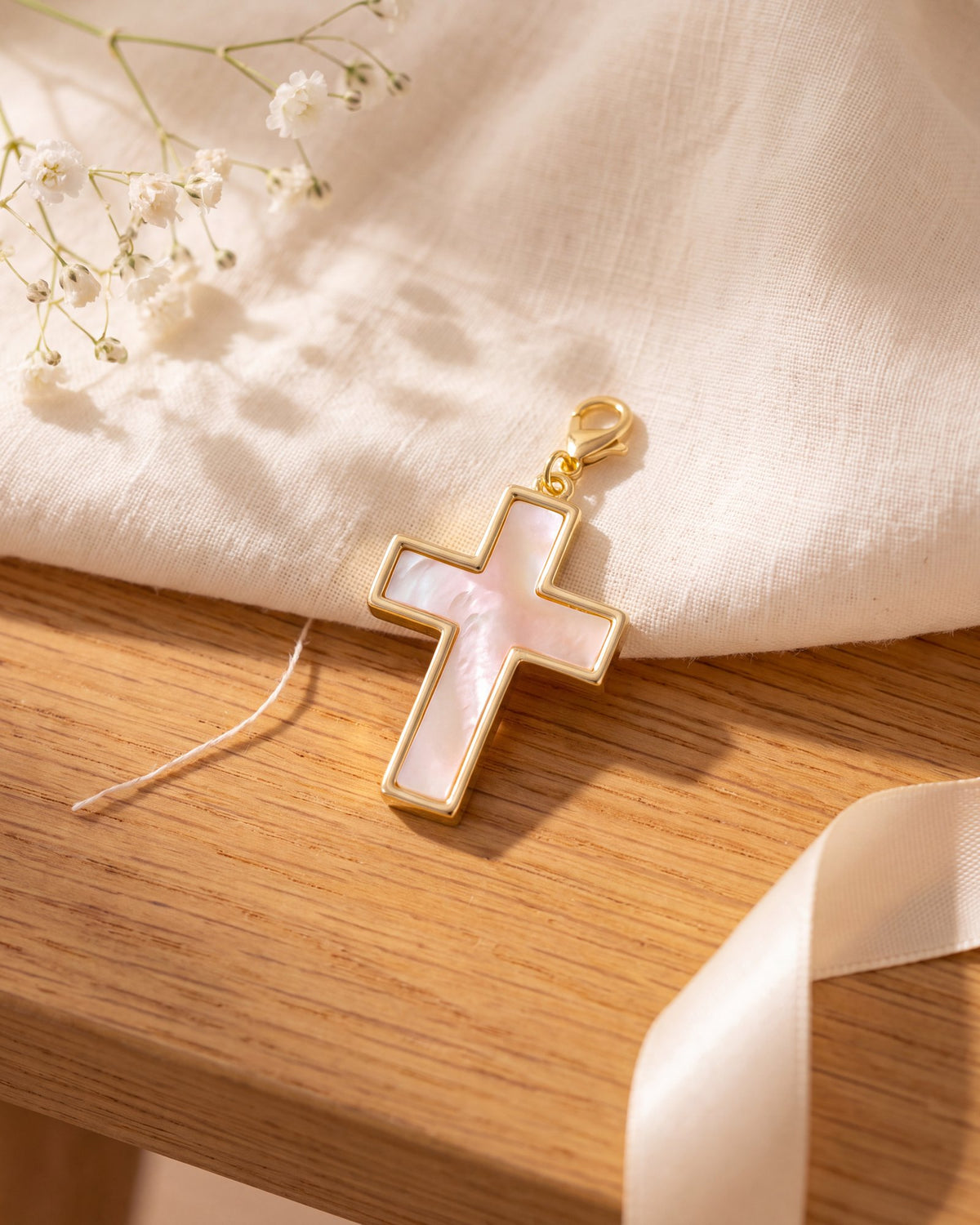 The pearl cross charm on its own